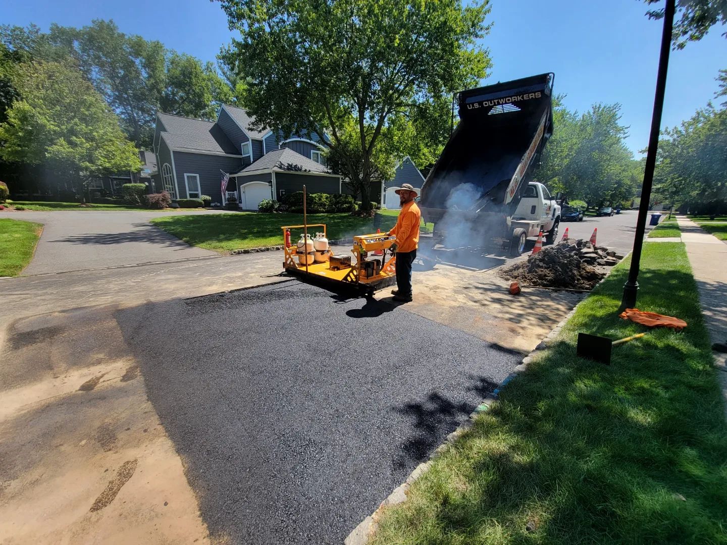 Contractors installing an asphalt pavement
