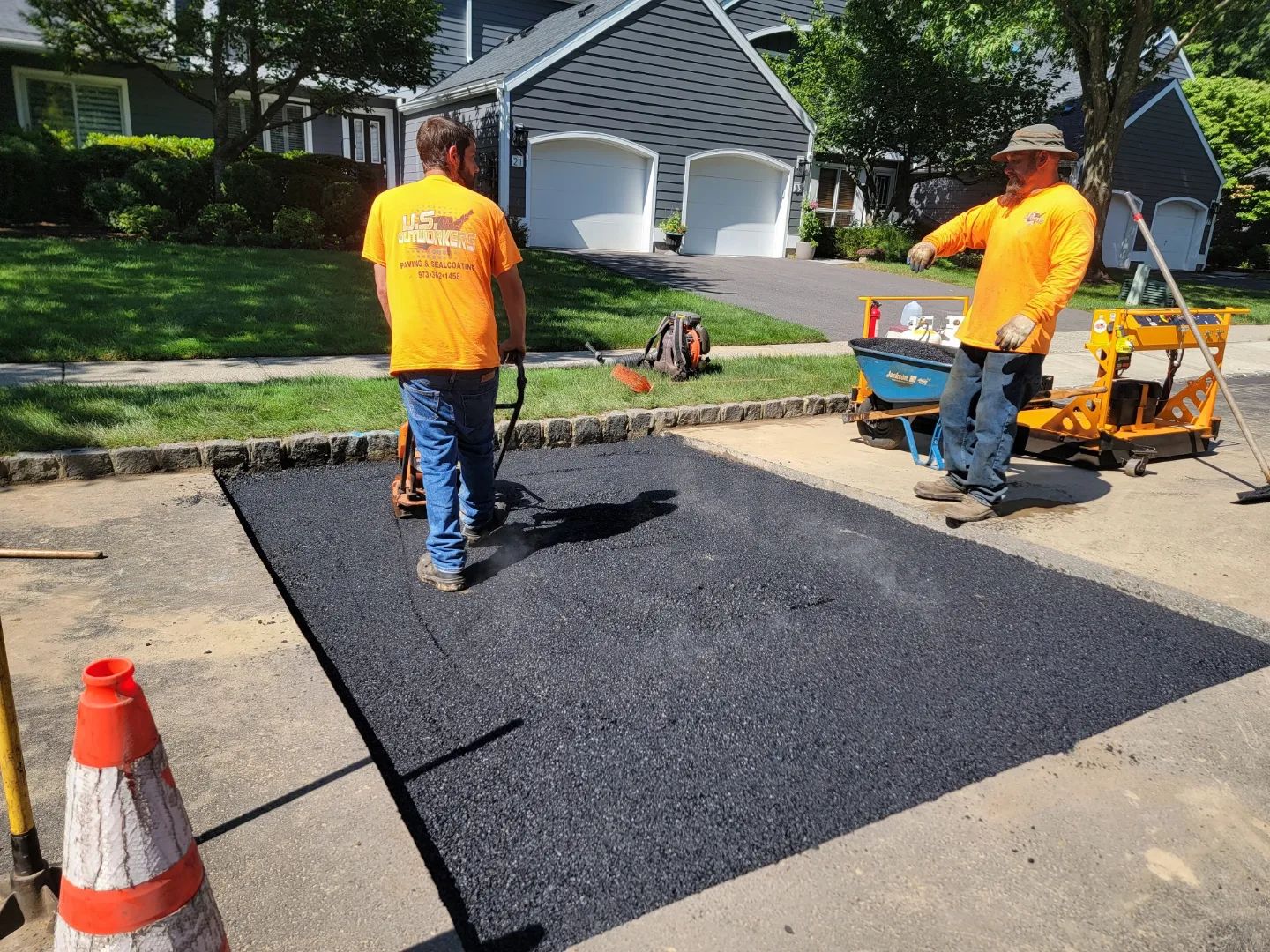 Two contractors working on a pavement